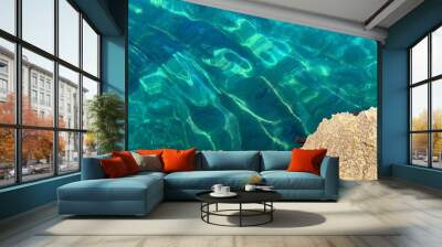 Sea blue turquoise water clear beautiful surface among coastal rocks. Wall mural