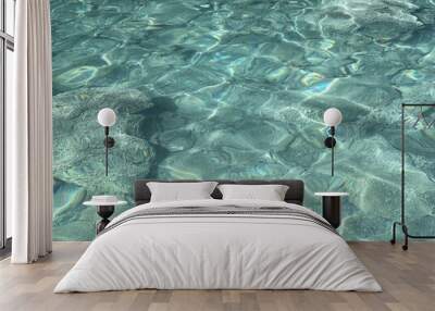 Water clear aqua surface underwater stones pebbles sand at the bottom. Wall mural