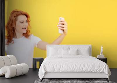 Woman isolated face portrait, banner with mock up copy space. Image of excited happy young woman isolated overyellow background make selfie by camera. Wall mural