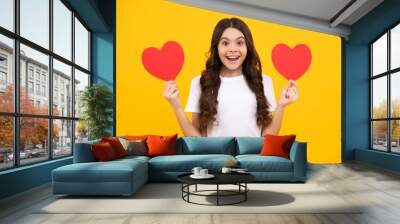 Young teenager child girl with heart shape. Happy Valentines Day. Love and pleasant feelings concept. Happy teenager, positive and smiling emotions of teen girl. Wall mural