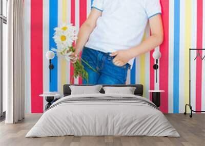 Adorable kid on colorful background. Cute child indoors in studio near the wall. Wall mural