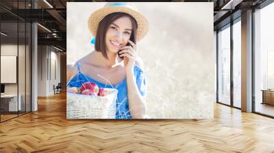 Attractive young woman on summer background. Smiling female portrait. Beautiful lady outdoors holding apples. Wall mural