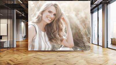 Beautiful blond woman closeup portrait outdoors. Smiling face. Lovely lady at summer background. Emotional female outdoors. Wall mural