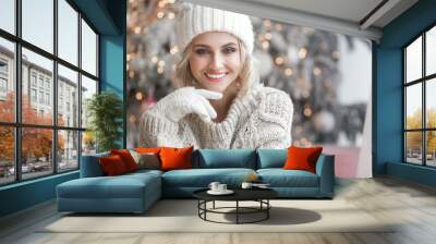 Beautiful blond woman on christmas background. Beauty near cristmas tree. Close up portrait of attractive female. Wall mural