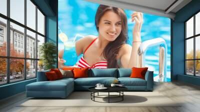 Close up portrait of a very beautiful young woman in the swimming pool Wall mural