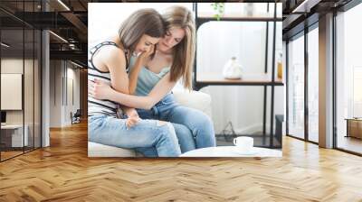 Friend trying to calm down her friend. Woman crying. Young lady sharing her problem with friend. female in depression. Wall mural