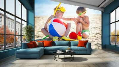 Pretty cute children on the beach having fun. Smiling kids in the summer time. Boys outdoors. Wall mural