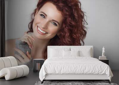 Very attractive young woman close up portrait. Beautiful female indoor. Curly haired lady. Red-haired girl. Redhead with wavy hair. Wall mural