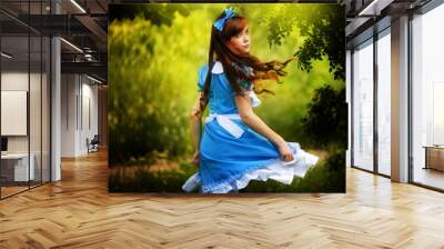 Girl in fairy tale park with tree in spring Wall mural