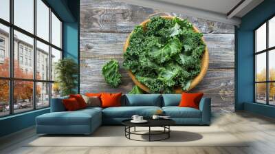 Fresh green curly kale leaves on a wooden table. selective focus. rustic style. healthy vegetarian food Wall mural