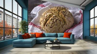 Simple rustic rye oat bread without yeast with seeds on a wooden table, selective focus Wall mural