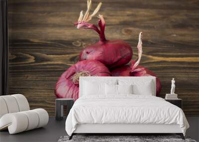 Sweet red onion on wooden background Wall mural