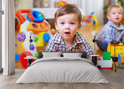 curious baby boy studying nursery room Wall mural