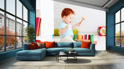 cute infant baby playing with wooden hammer block toy Wall mural