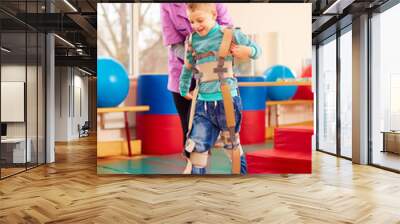 cute kid having physical musculoskeletal therapy in rehabilitation center Wall mural