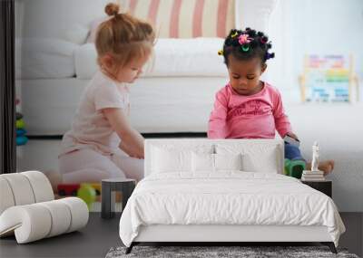 cute toddler baby girls playing toys together on the carpet Wall mural