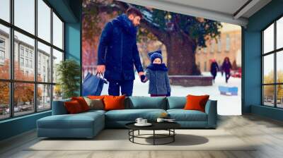 father and son walking on winter shopping Wall mural