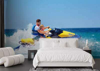 happy, excited family, father and son having fun on jet ski at summer vacation Wall mural