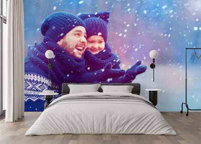 happy father and son having fun under winter snow Wall mural