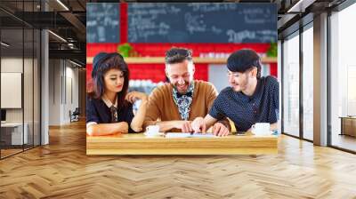 happy friends sitting in cafe, studying Wall mural