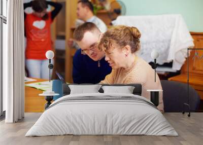 two friends with disability in rehabilitation center, watching digital tablet Wall mural