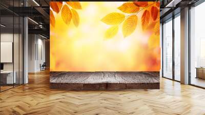 Empty wooden table and orange autumn leaves over blurred nature background. Fall background with empty space for product display Wall mural