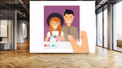 Hand holds a photo with a picture of a couple. Concept of friendship and fun with new trends and technology. Wall mural