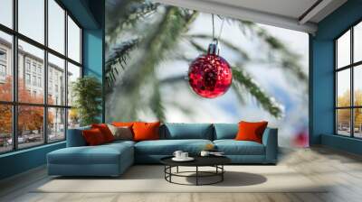 Outdoors image of beautiful decorated christmas fir tree on the white snow background. Christmas vacation out of town. Christmas tree branches with red balls. Christmas decoration. New Year  Wall mural