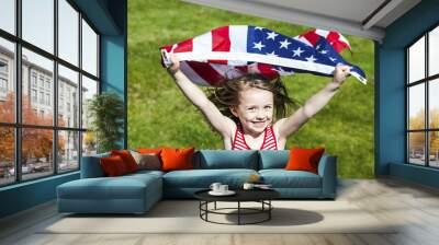 Patriotic holiday  child with American flag running.  Wall mural