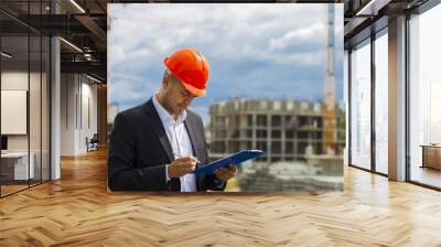 Worker inspector  in helmet checking  construction  Wall mural