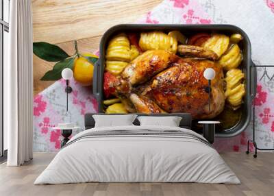 Spicy roasted baked chicken with potatoes.  Festive bird baked with vegetables on the table Wall mural