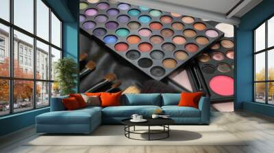 A palette of shadows and brushes on the table next to the flowers Wall mural