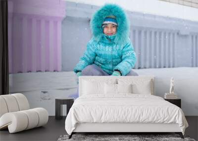 Happy kid girl child outdoors in winter playing with snow Wall mural