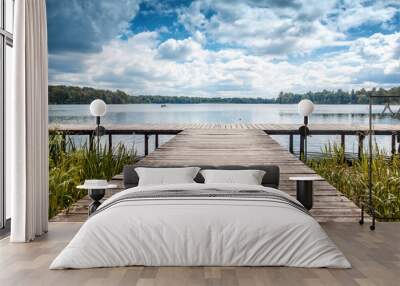 Beautiful summer landscape with dramatic sky, wooden pier on the lake, Trakai, Lithuania Wall mural