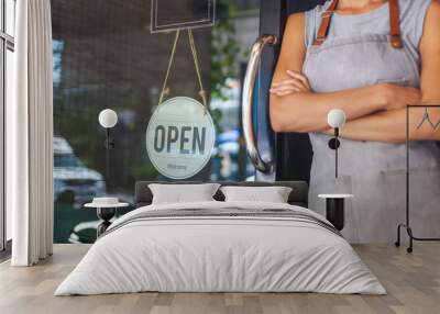 The woman is a waitress in an apron, the owner of the cafe stands at the door with a sign Open waiting for customers. Small business concept, cafes and restaurants Wall mural