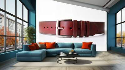 Brown leather belt with silver buckle on a white background Wall mural