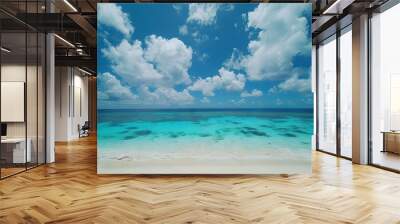  A blue beach with crystal-clear water, a cloudy blue sky, and white sand Wall mural