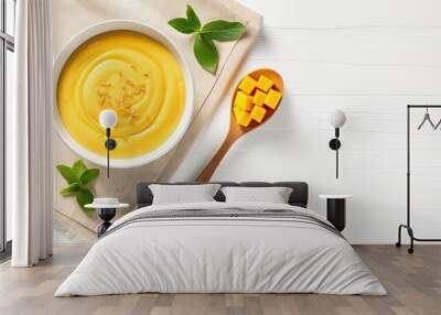  a bowl of mango custard and a spoon on a napkin.  generative ai Wall mural