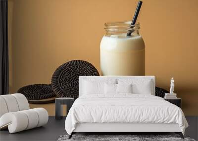   A glass of milk and cookies on a brown background Wall mural