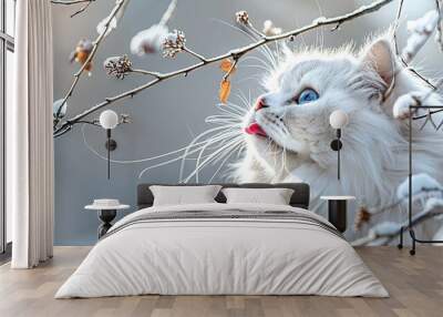   A white cat with blue eyes sits on a snow-covered branch while gazing upward at the sky Wall mural