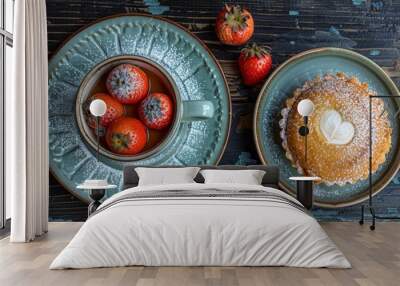   Table topped with two plates of food and a cup filled with powdered sugar beside strawberries Wall mural