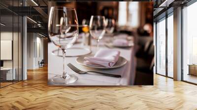 A close up shot of a restaurant table set up with tableware and wine glass. Concept of dining, hospitality and catering. Horizontal image with free space for text. Wall mural