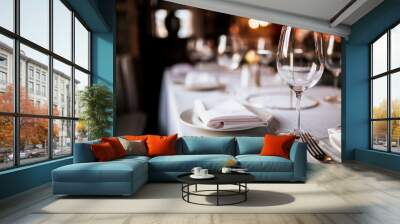 A close up shot of a restaurant table set up with tableware and wine glass. Concept of dining, hospitality and catering. Horizontal image with free space for text. Wall mural