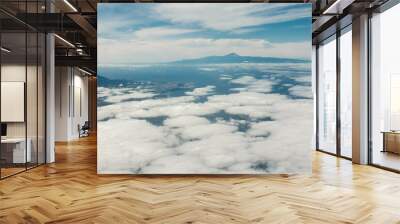 
Aerial view of Gran Canaria island and Teide volcano in Tenerife island, Spain. Aerial view from airplane window on blue sky with clouds over a landscape. Wall mural