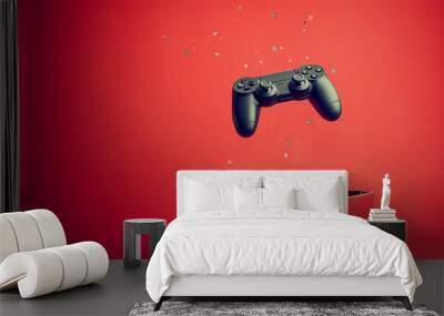 Black gaming joystick controller gamepad  and box with glitter on red background, gift for gamer	 Wall mural