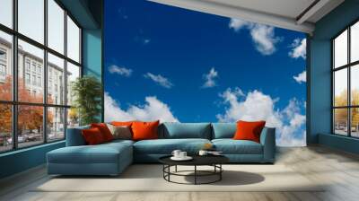 Blue, bright sky background with white clouds clouds. Wall mural