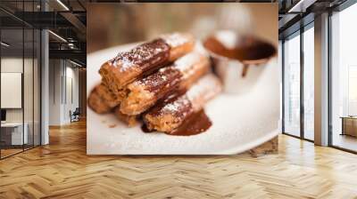 Cinnamon sugar dusted churros with chocolate sauce. Concept of food, dessert and baking. Traditional Mexican food. Wall mural