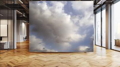 Clouds in the blue sky. A stunning gray sky. The storm is approaching. A beautiful clouds against the blue sky background. Amazing cloud pattern in the sky. Wall mural