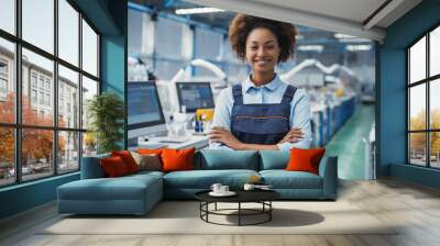 Female facility, afroamerican woman engineer in modern technical plant, smiling on camera Wall mural