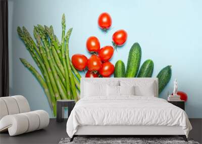 Fresh vegetables on a blue background. Crops. Asparagus, tomatoes, cucumbers. Flat lay. The concept of proper nutrition. Wall mural